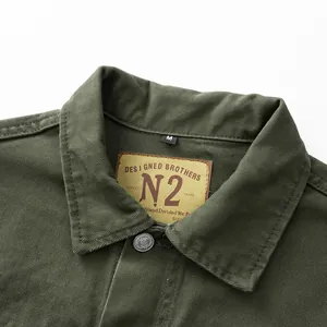 Vintage olive green denim jacket collar detail with N2 brand label and metal button