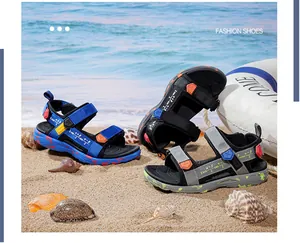 Detailed view of lightweight boys' summer beach sandals on a sandy shore