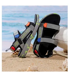 Side view of lightweight boys' summer beach sandals on a sunny sandy beach setting