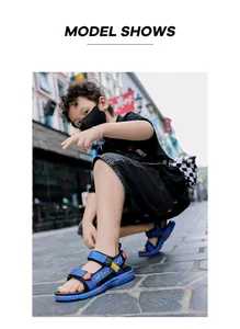 Detail view of stylish blue boys' sandals on a model in an urban street setting