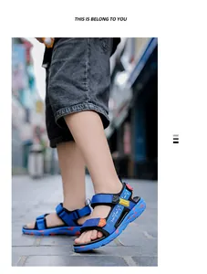 Close-up of boys' blue lightweight beach sandals with soft sole worn by model