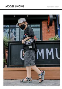 Detailed side view of boys' grey summer sandals worn by a model in an urban setting