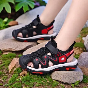 Boys' black and red closed-toe summer sandals with anti-slip soles for outdoor beach play.
