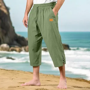 Side view detail of men's sage green linen cropped pants featuring a drawstring waist.