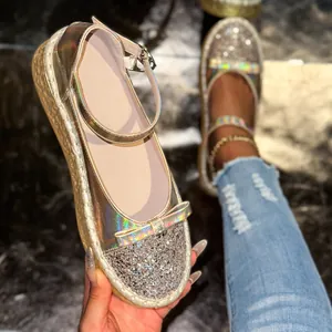 Close-up detail of holographic Mary Jane flats with sparkly sequin toe and platform sole