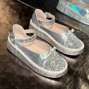 Close-up of silver holographic Mary Jane shoes featuring glitter toe and platform sole