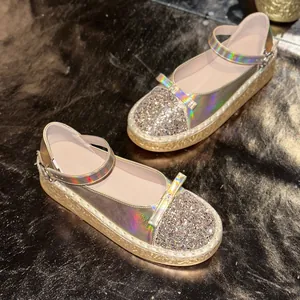 Macro detail of holographic Mary Jane shoes with glitter sequin toe cap and bow accent