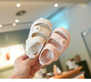 Detailed view of cream and pink toddler walking sandals with quilted velcro straps