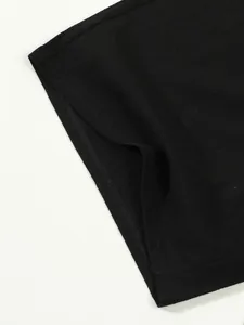 Close-up detail of black cotton linen shorts showing fine stitching and fabric texture