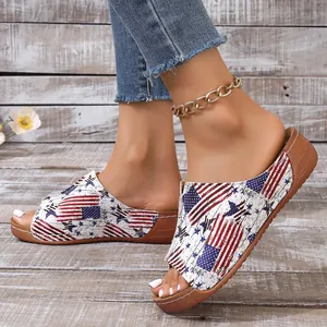 Detailed view of women's peep-toe wedge slides with American flag stars and stripes pattern.