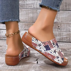 Close-up of women's peep-toe wedge slippers with American flag print and thick sole