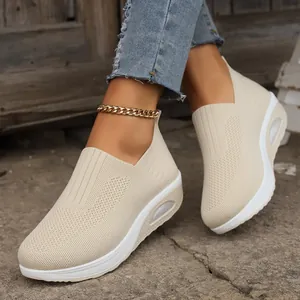 Close-up of women's beige flyknit slip-on shaker shoes with breathable platform soles
