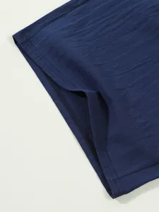 Close-up detail of navy blue cotton linen men's casual shorts hem showing fabric texture