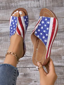 Close-up of women's summer wedge sandals with a patriotic US flag print and comfortable sole