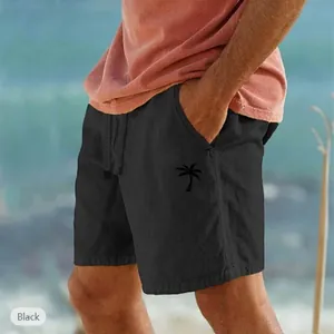 Vista dettagliata di pantaloncini da spiaggia neri in cotone e lino con una palma