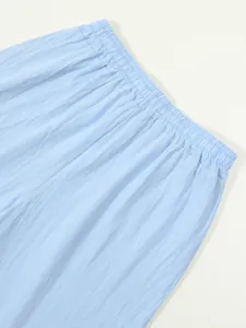 Detailed macro view showing the elastic waistband of light blue cotton linen casual shorts