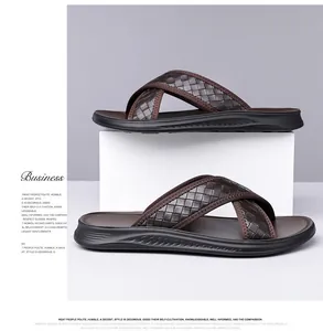 Detail view of men's cross-strap sandals with woven brown texture and black sole