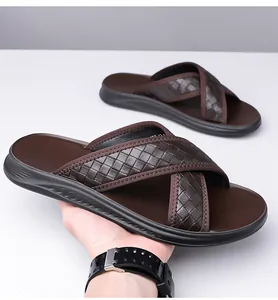 Close-up detail of men's brown woven slide sandals featuring a stylish cross-strap design