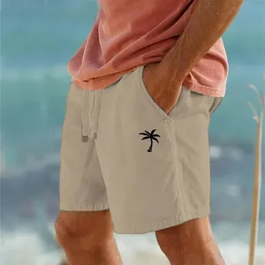 Vista dettagliata dei pantaloncini da spiaggia beige in cotone e lino con stampa cocco.