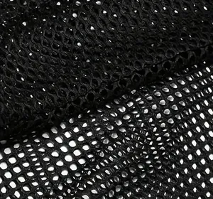 Macro view showing the breathable black honeycomb mesh fabric texture of the men's vest