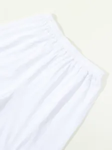 Close-up detail of white summer cotton linen shorts featuring comfortable elastic waistband