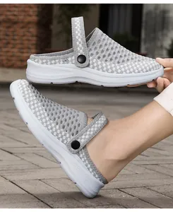 Detailed view of grey breathable mesh clogs with a comfortable lightweight white sole