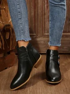 Stylish black pointed-toe block heel ankle boots featuring side zipper and buckle detail.