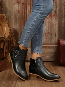 Elegant black pointed toe ankle boots with buckle straps and low block heel detail