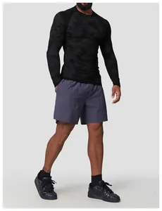 Detail shot of a black camo seamless long-sleeve athletic t-shirt on a model
