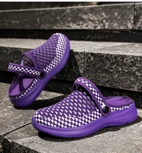 Close-up of purple and white checkered breathable mesh slip-on clogs on stone steps