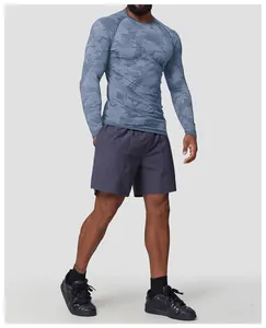 Men's blue camo seamless long-sleeve fitness T-shirt worn by a professional male model