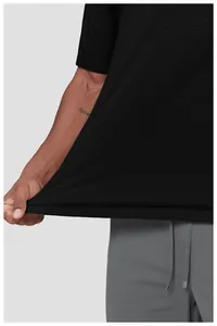 Close-up of black breathable athletic tee showing rippled texture and fabric stretch