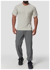 Detail view of a men's athletic short-sleeve shirt paired with grey joggers for fitness.