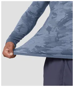 Close-up detail of seamless jacquard athletic shirt showing fabric texture and elastic stretch.