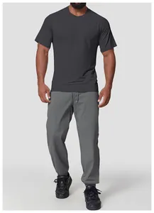 Detail view of men's charcoal seamless athletic t-shirt and grey joggers set