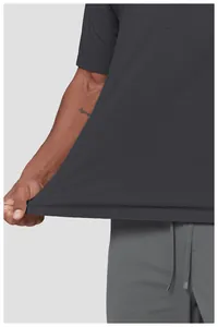 Close-up of textured charcoal grey quick-dry sports t-shirt showing fabric elasticity