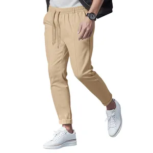 Detailed look at men's beige slim fit casual chino trousers with drawstring waistline