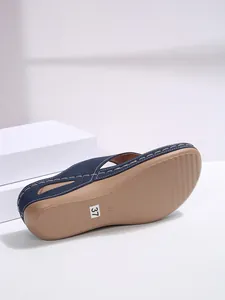 Detailed close-up of navy blue wedge sandal sole featuring a size 37 sticker label