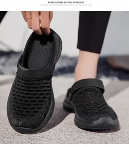 Close-up detail of breathable flyknit mesh upper on black summer clogs for women