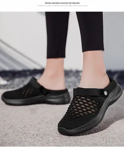 Macro view of black breathable fly-knit mesh texture on women's trendy half-slippers