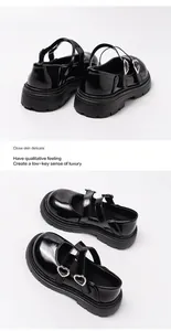 Detailed view of black patent leather girls Mary Jane shoes featuring heart-shaped buckles
