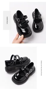 Detail view of black patent leather Mary Jane shoes for girls with heart buckles