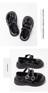 Macro view of black patent leather girls Mary Jane shoes featuring silver heart buckles