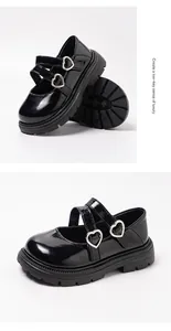Detailed macro view of black patent leather girls' shoes with heart buckles