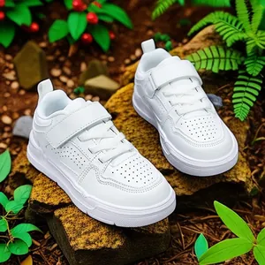 White casual sneakers for kids with breathable perforated upper in outdoor setting
