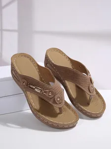 Detail view of brown wedge flip-flop sandals with metal chain and perforated design.