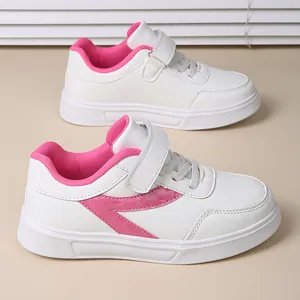 Stylish girls' white sneakers with pink accents and comfortable Velcro strap closure