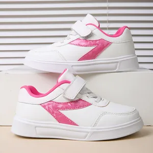 Fashionable girls' white sneakers with pink geometric accents and convenient velcro strap
