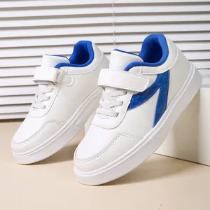 Comfortable children's white sneakers featuring blue lining and durable velcro straps