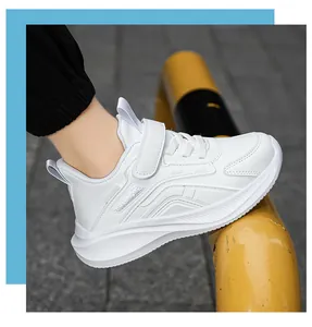 Side view of white breathable kids sneakers on foot with velcro strap detail